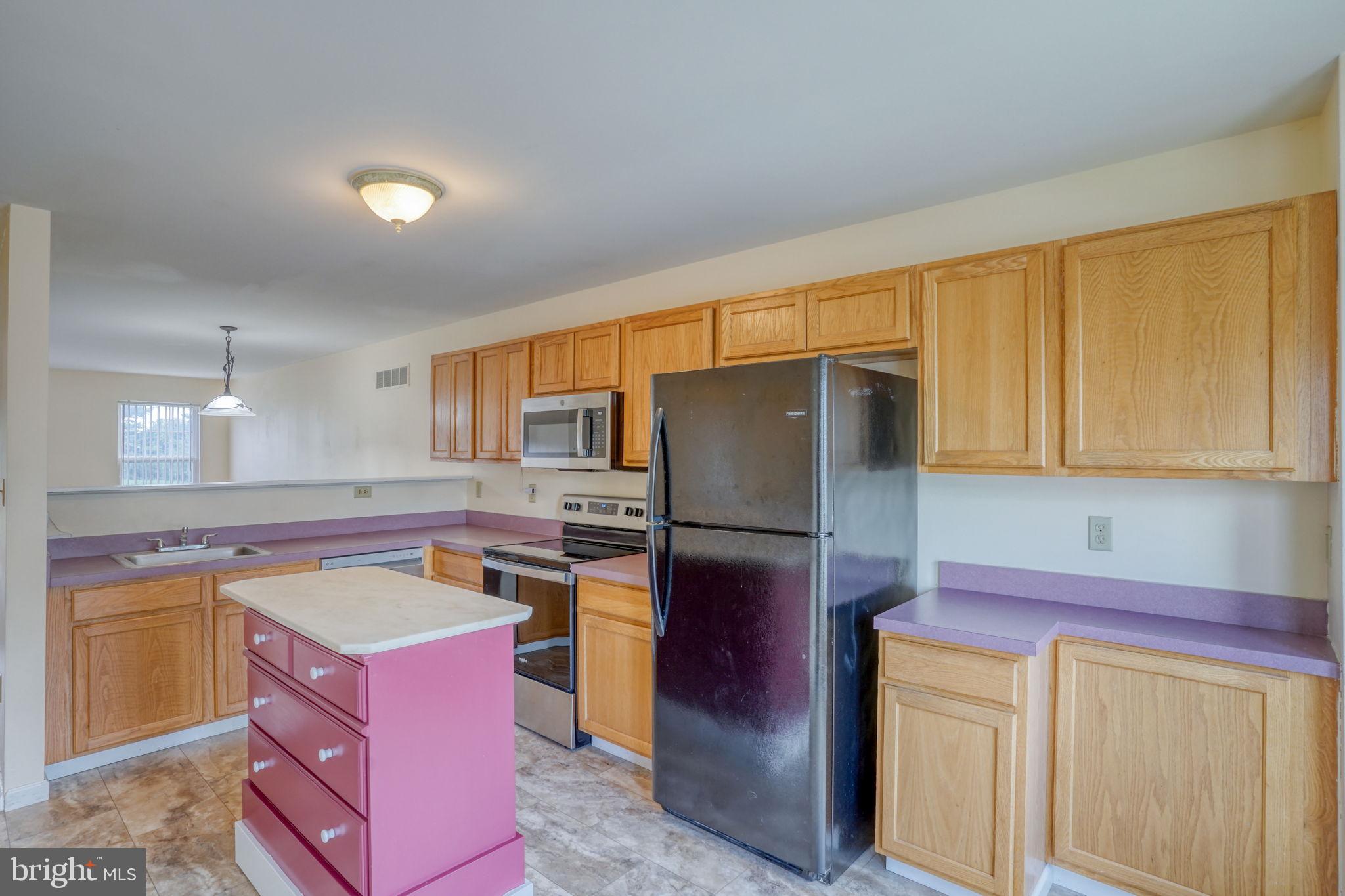 197 Bonnybrook Road Middletown, DE 19709 - Photo 4 of 32 a kitchen with a refrigerator sink and cabinets