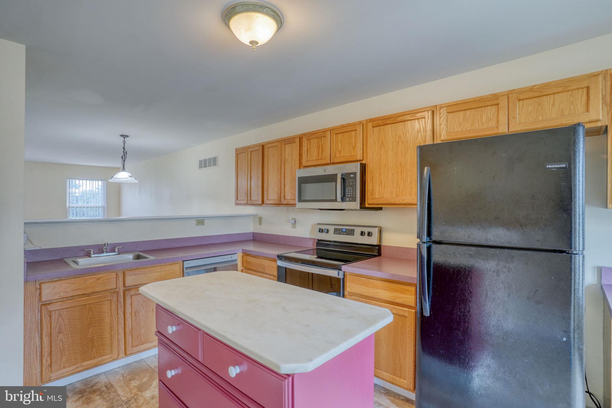 197 Bonnybrook Road Middletown, DE 19709 - Photo 5 of 32 a kitchen with stainless steel appliances a refrigerator sink and microwave