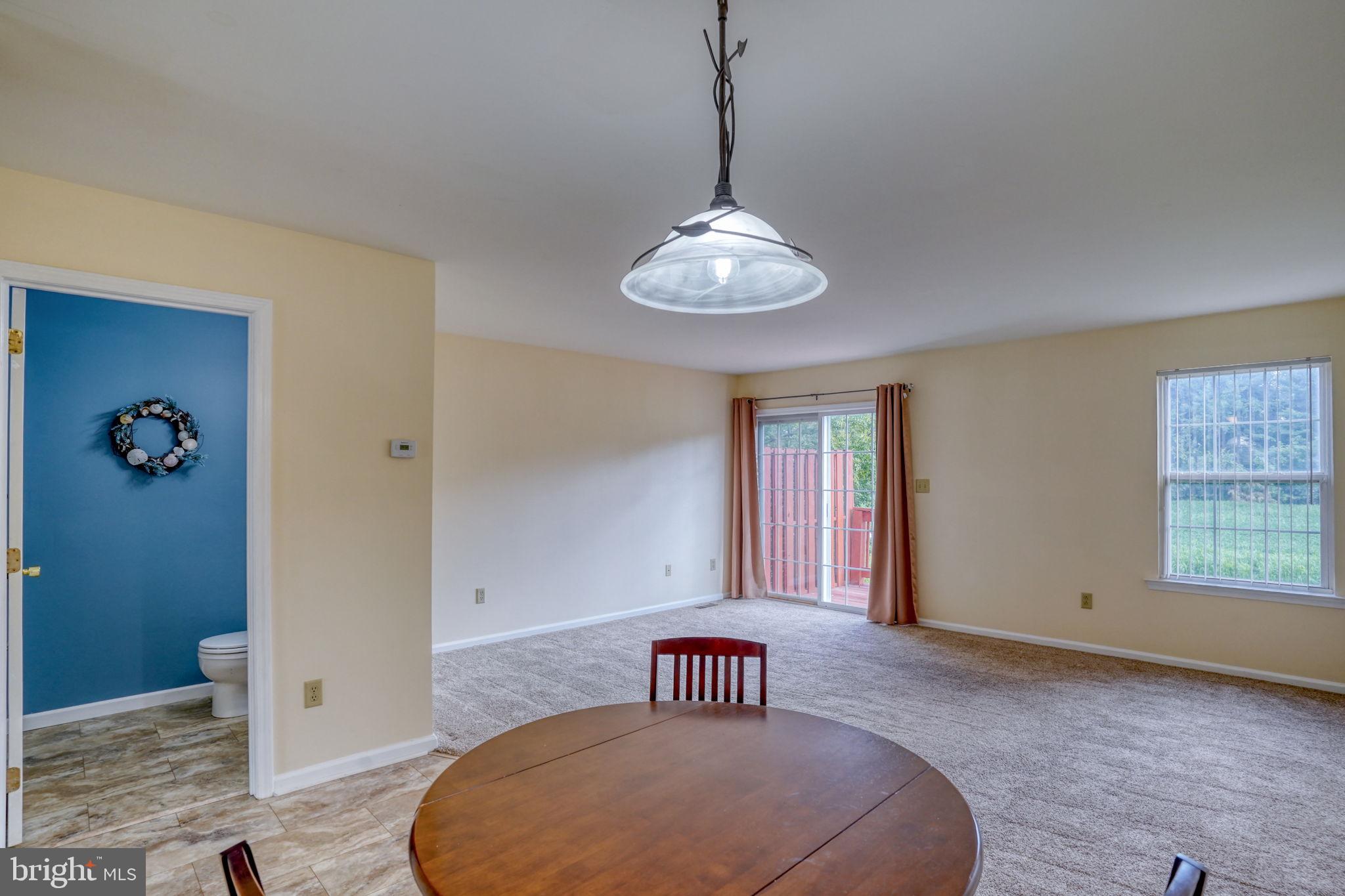 197 Bonnybrook Road Middletown, DE 19709 - Photo 10 of 32 a view of a livingroom with a chandelier fan and windows
