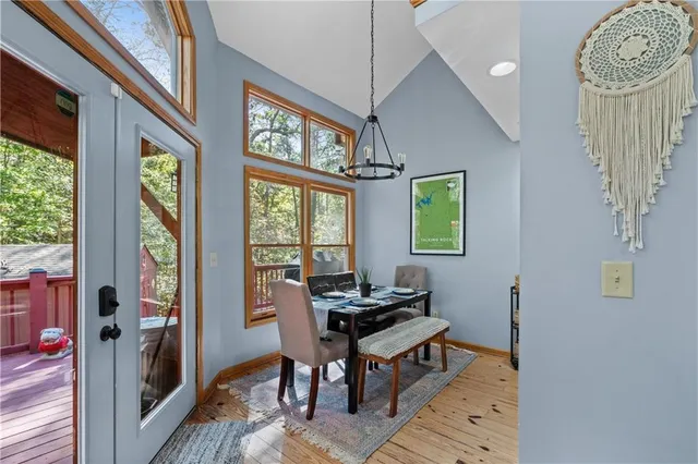 a living room with furniture a flat screen tv and kitchen view