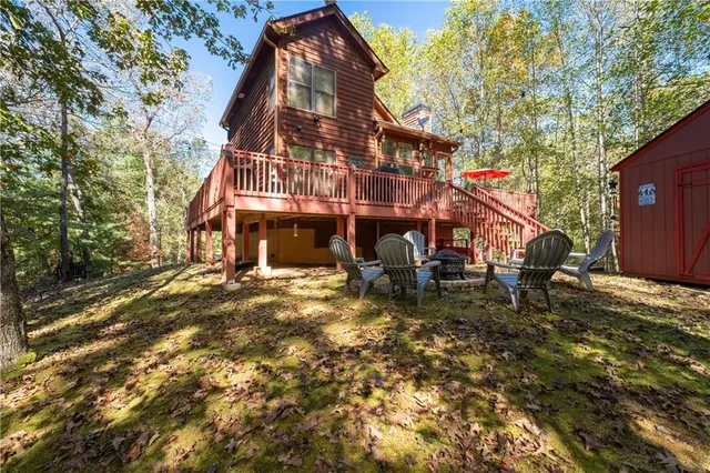 an aerial view of a house with large trees
