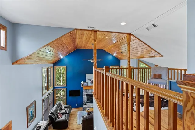 a view of a house with a small yard and large tree