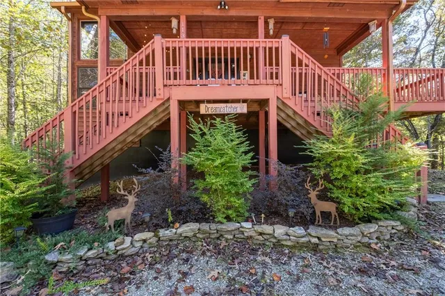 a living room with furniture large window and fireplace