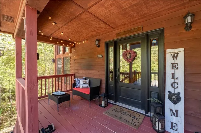 a living room with furniture a flat screen tv and a large window