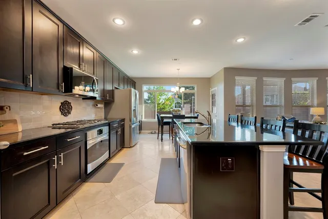 a kitchen with stainless steel appliances granite countertop lots of counter top space