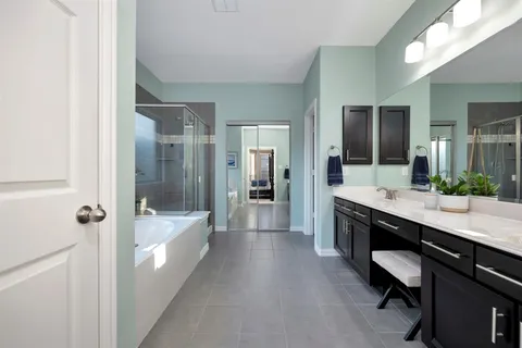 a large bathroom with a double vanity sink a large mirror and shower