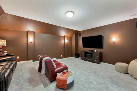 a spacious bedroom with a bed and a flat screen tv