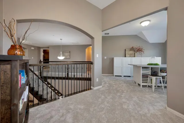 a view of a livingroom with furniture and staircase