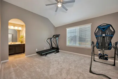 a room with gym equipment and a large window