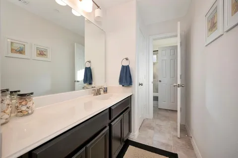 a en suite bathroom with a double vanity sink a mirror and a shower