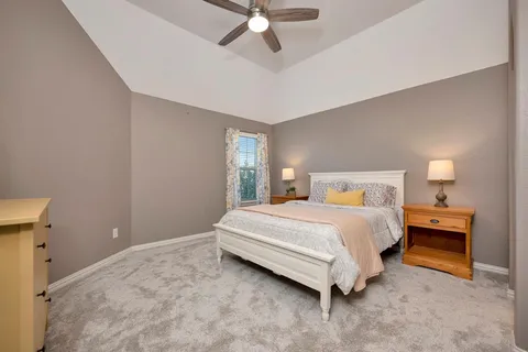 a bedroom with a bed lamp and a fireplace