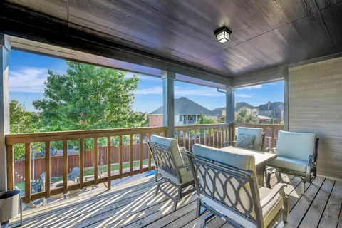 a view of a balcony with furniture