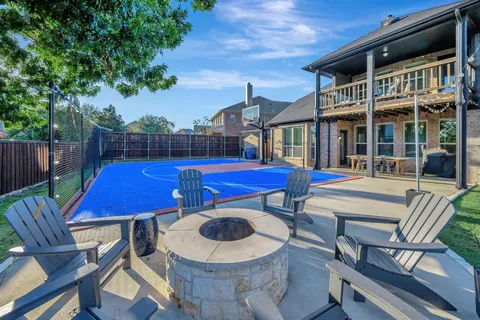 a view of a patio with table and chairs and potted plants with wooden floor and fence