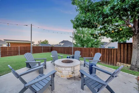 a view of backyard of house with seating space