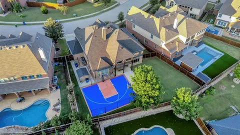 an aerial view of a house with a yard and potted plants