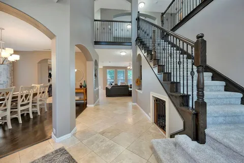 a view of entryway and hall with wooden floor