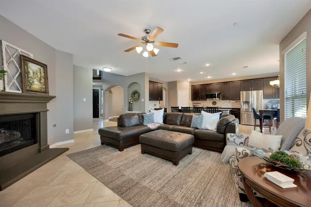 a living room with furniture kitchen view and a fireplace