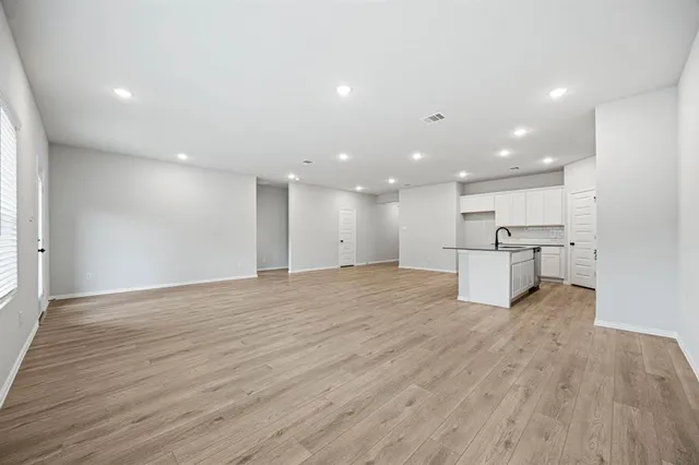 a kitchen with white cabinets appliances and sink