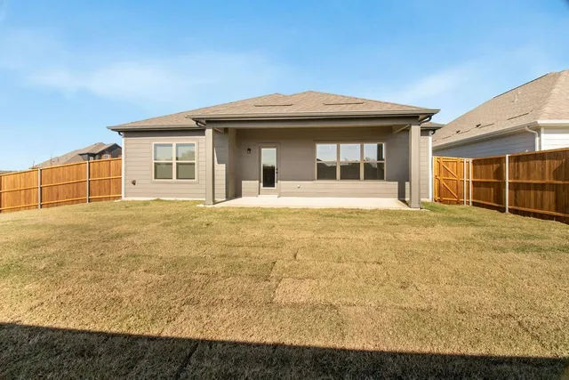 a big house with a big yard and large trees