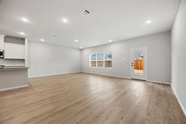 a view of kitchen with kitchen island and wooden floor
