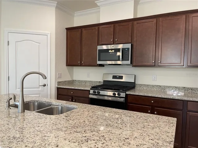 a front view of house with a yard and potted plants
