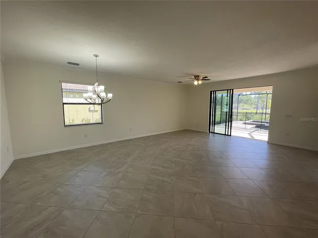 a view of a livingroom with a ceiling fan and window