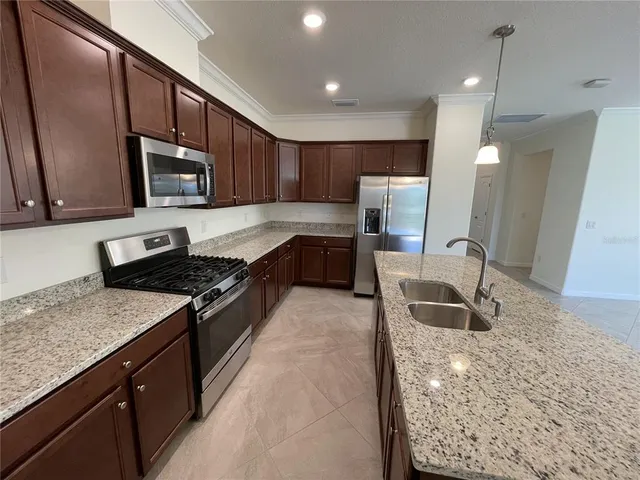 a bathroom with a granite countertop sink toilet mirror and bathtub