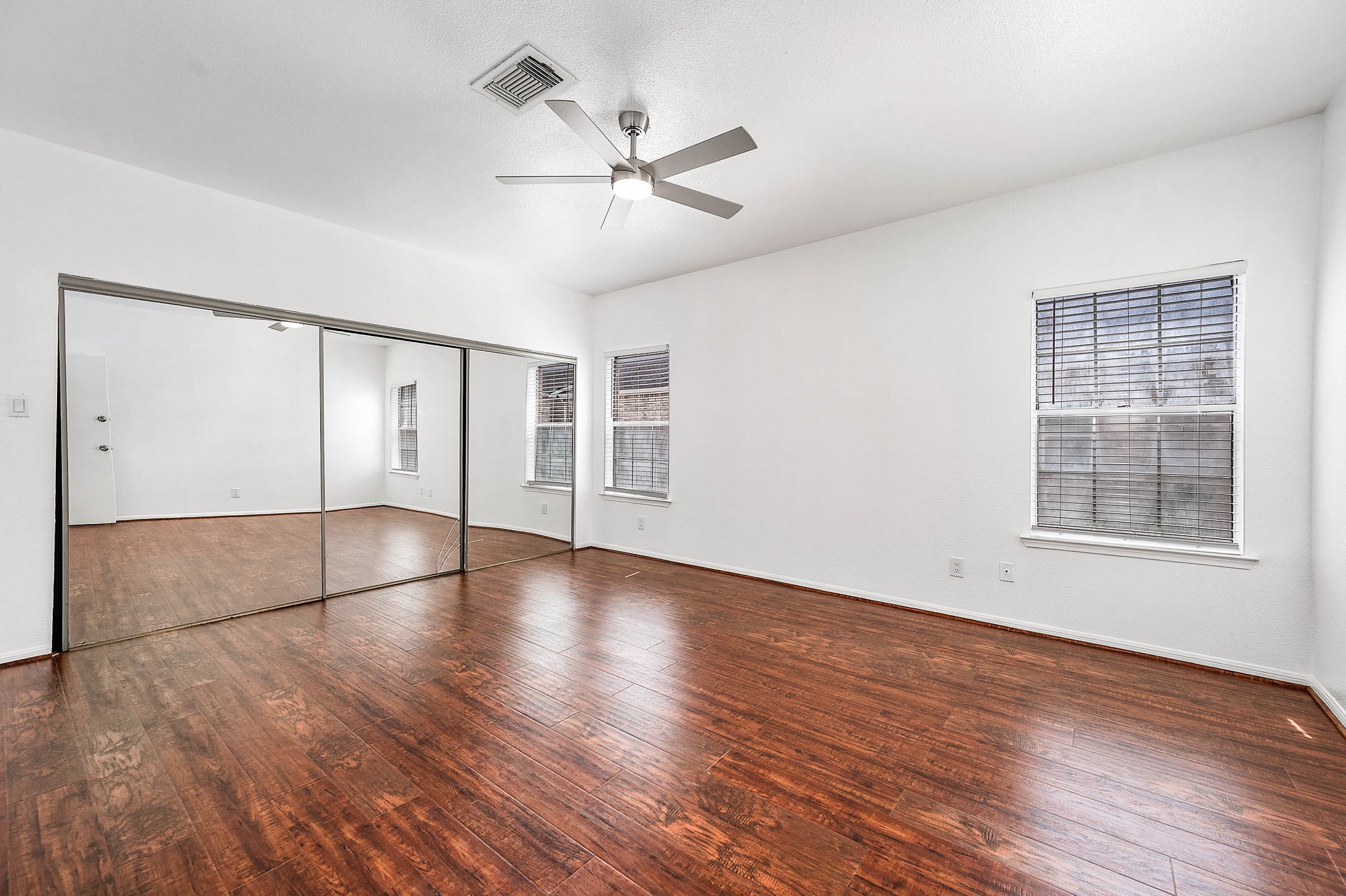 6000 Reims Road, Unit 2003 Houston, TX 77036 - Photo 19 of 24 an empty room with wooden floor chandelier and windows