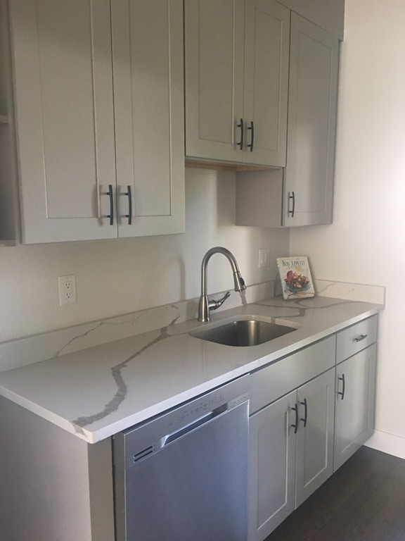 45 Clement Avenue, Unit 3 Boston, MA 02132 - Photo 12 of 35 a kitchen with white cabinets and a sink
