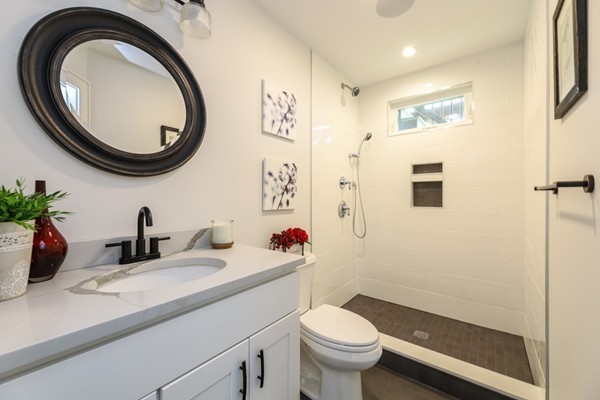 45 Clement Avenue, Unit 3 Boston, MA 02132 - Photo 17 of 35 a bathroom with a sink a mirror and a toilet