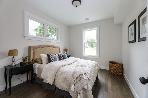 45 Clement Avenue, Unit 3 Boston, MA 02132 - Photo 21 of 35 a bedroom with a bed and wooden floor