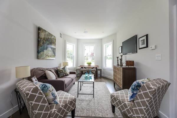 45 Clement Avenue, Unit 3 Boston, MA 02132 - Photo 4 of 35 a living room with furniture a flat screen tv and a window