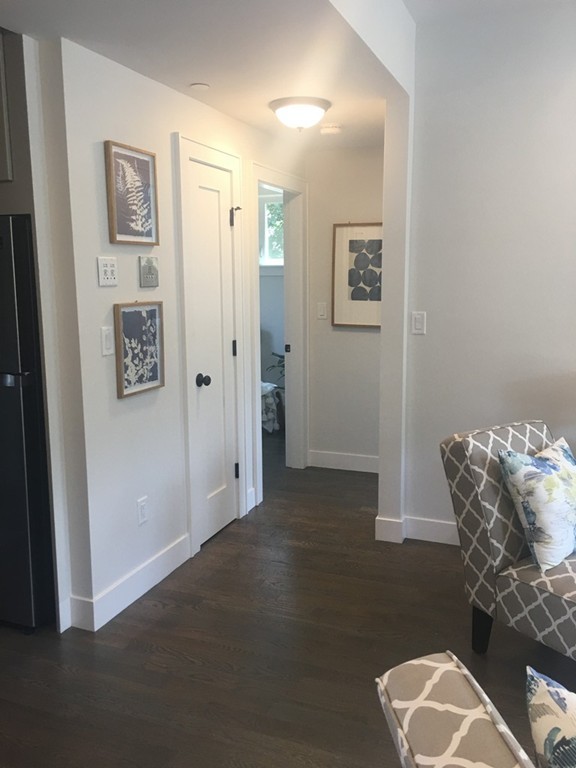 45 Clement Avenue, Unit 3 Boston, MA 02132 - Photo 8 of 35 a view of a hallway with paintings on the wall