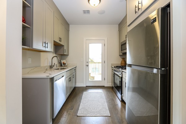 45 Clement Avenue, Unit 3 Boston, MA 02132 - Photo 10 of 35 a kitchen with a refrigerator a sink and a stove