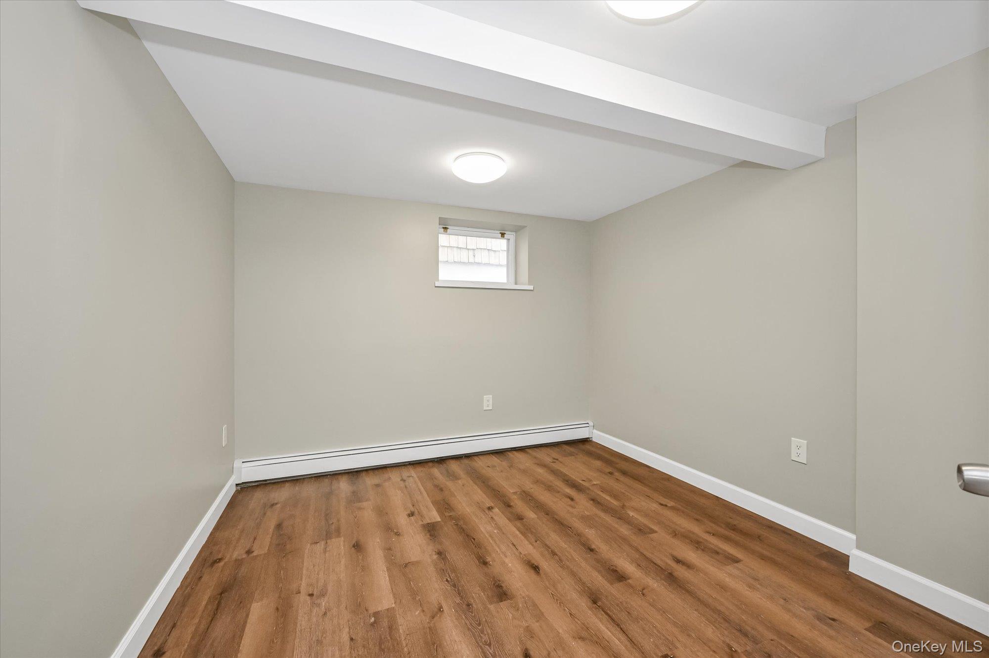 64-39 58th Road Queens, NY 11378 - Photo 14 of 19 a view of empty room with wooden floor