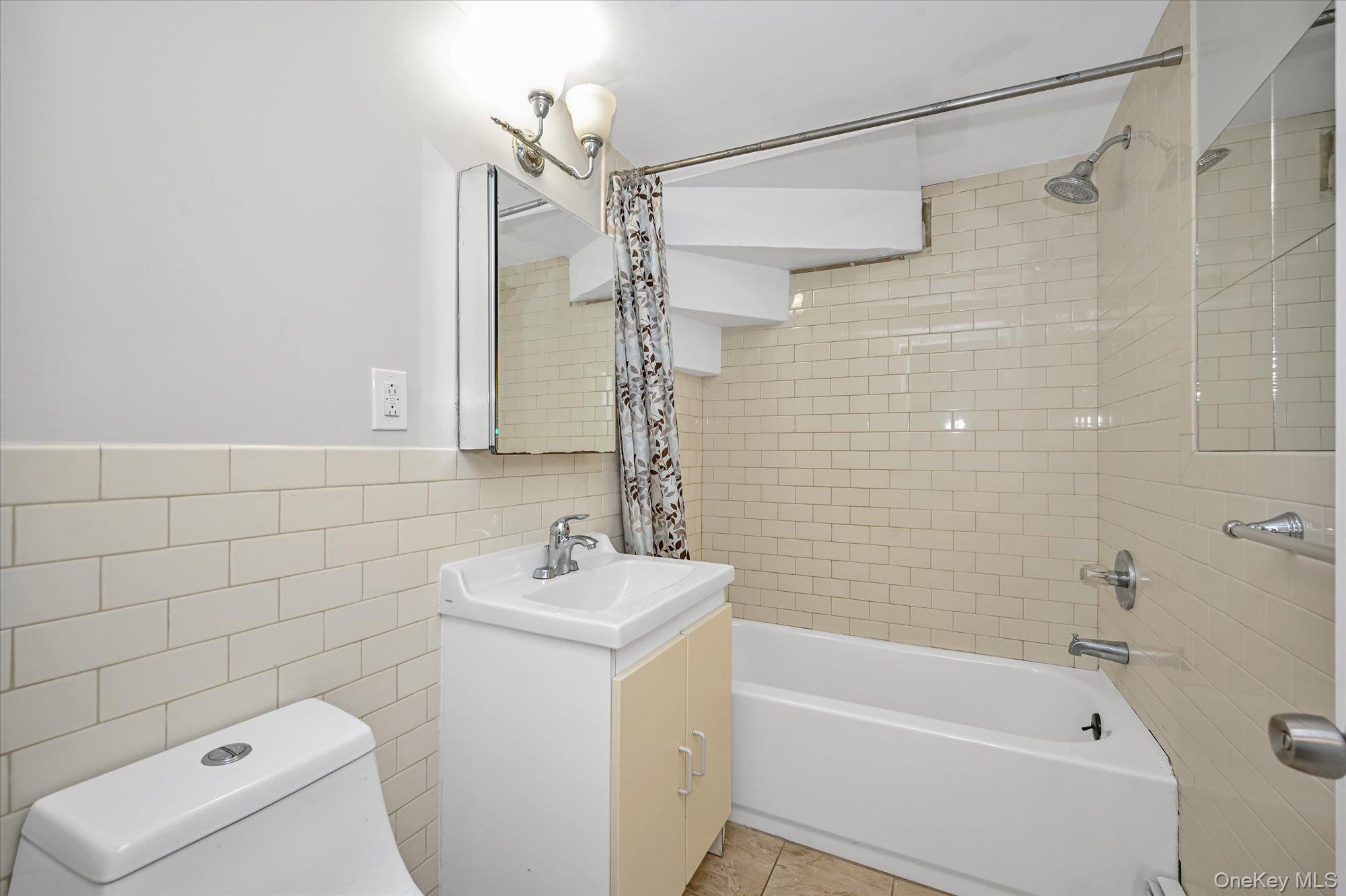 64-39 58th Road Queens, NY 11378 - Photo 15 of 19 a bathroom with a sink a toilet and shower