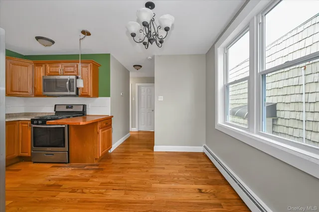 a kitchen with stainless steel appliances granite countertop a stove a sink and a window