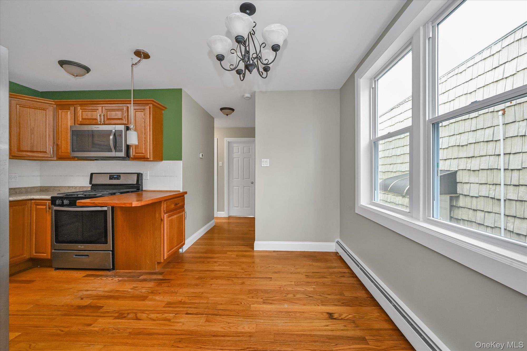 64-39 58th Road Queens, NY 11378 - Photo 5 of 19 a kitchen with stainless steel appliances granite countertop a stove a sink and a window