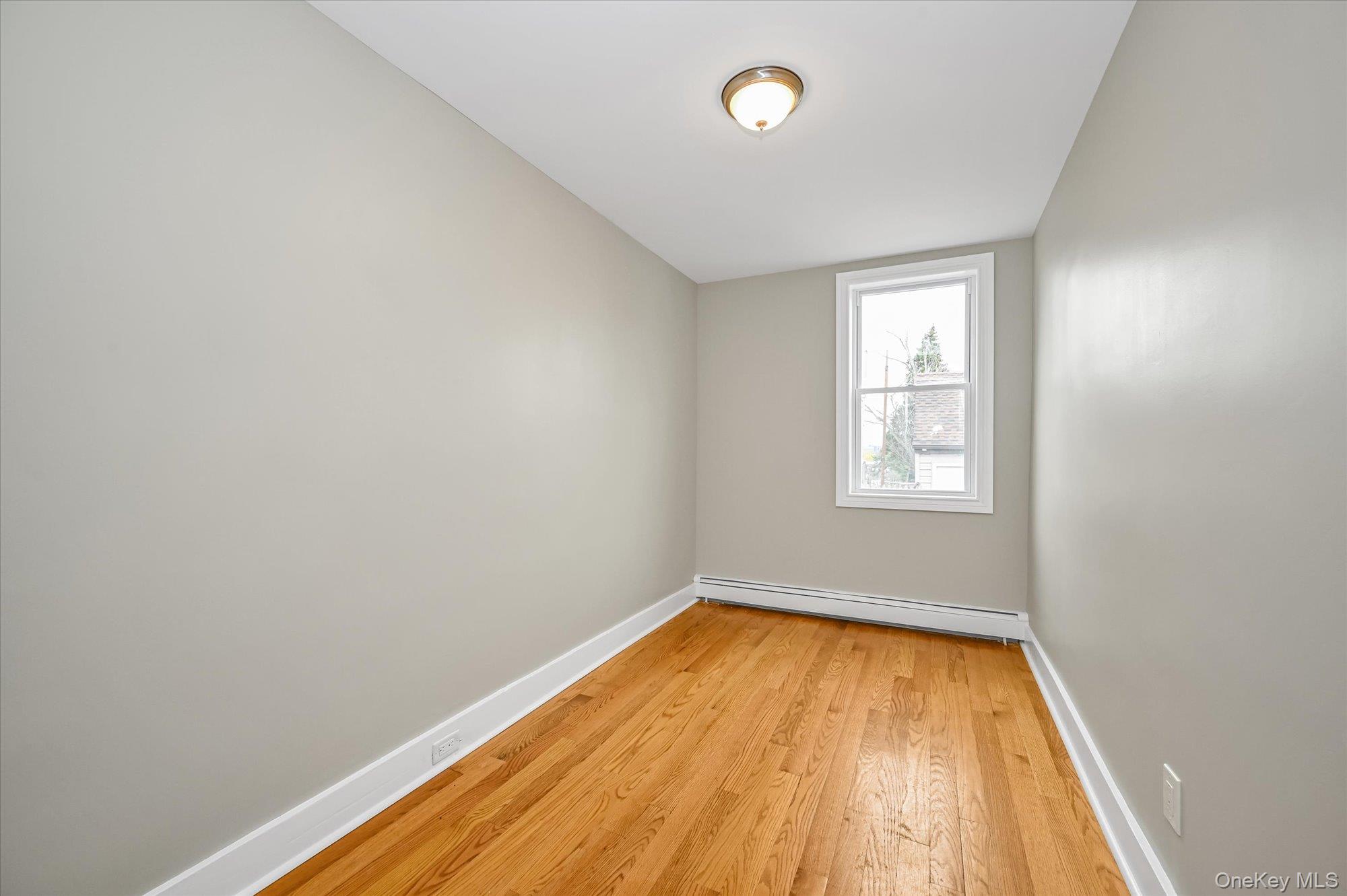 64-39 58th Road Queens, NY 11378 - Photo 6 of 19 an empty room with a window