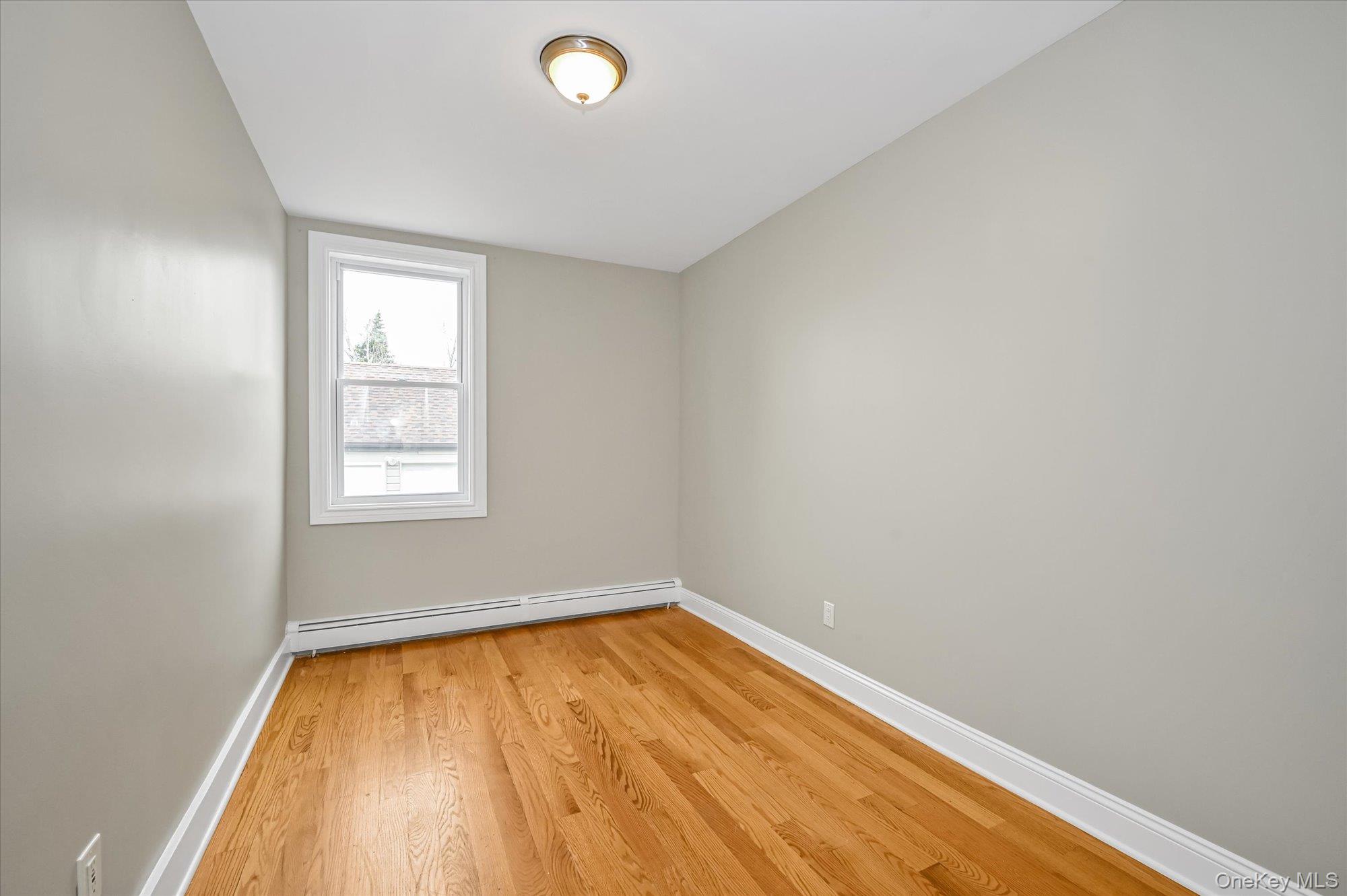 64-39 58th Road Queens, NY 11378 - Photo 7 of 19 an empty room with a window