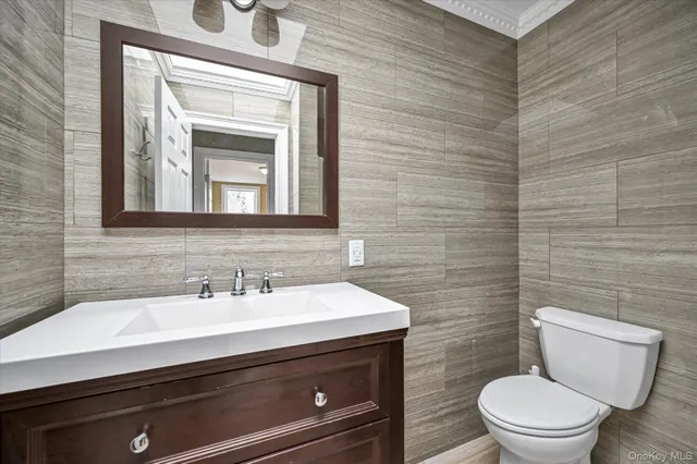 a bathroom with a toilet a sink and mirror