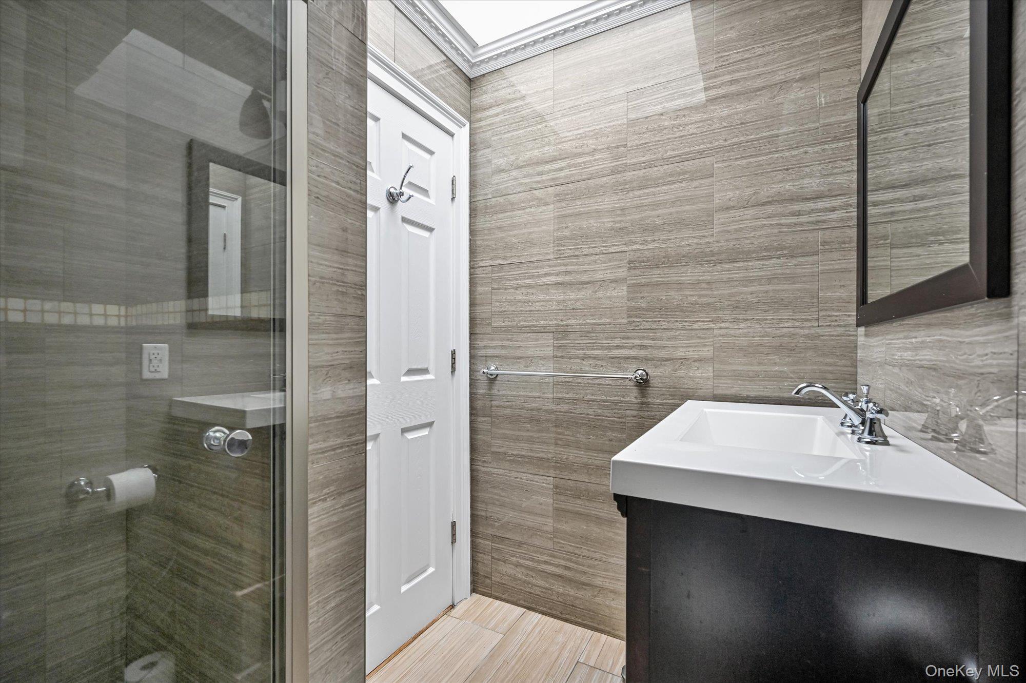 64-39 58th Road Queens, NY 11378 - Photo 9 of 19 a bathroom with a sink and a mirror