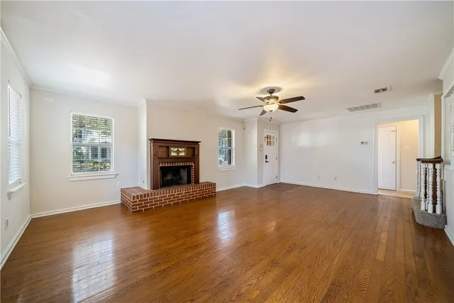 a view of a livingroom with wooden floor and a ceiling fan