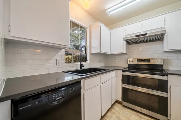 a kitchen with a stove and a sink