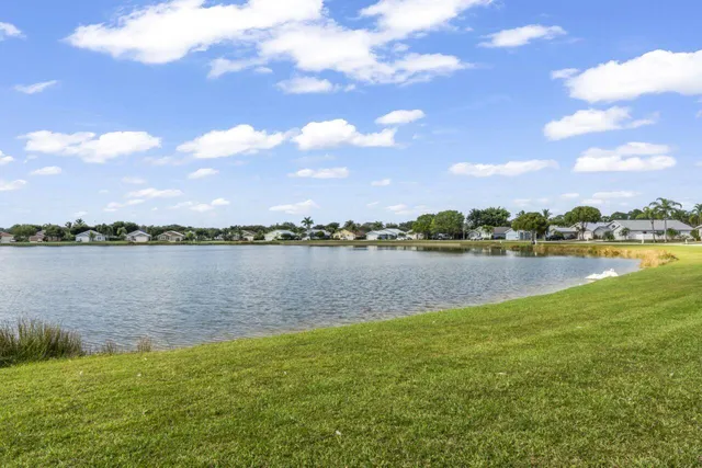 a view of a lake with houses in the back