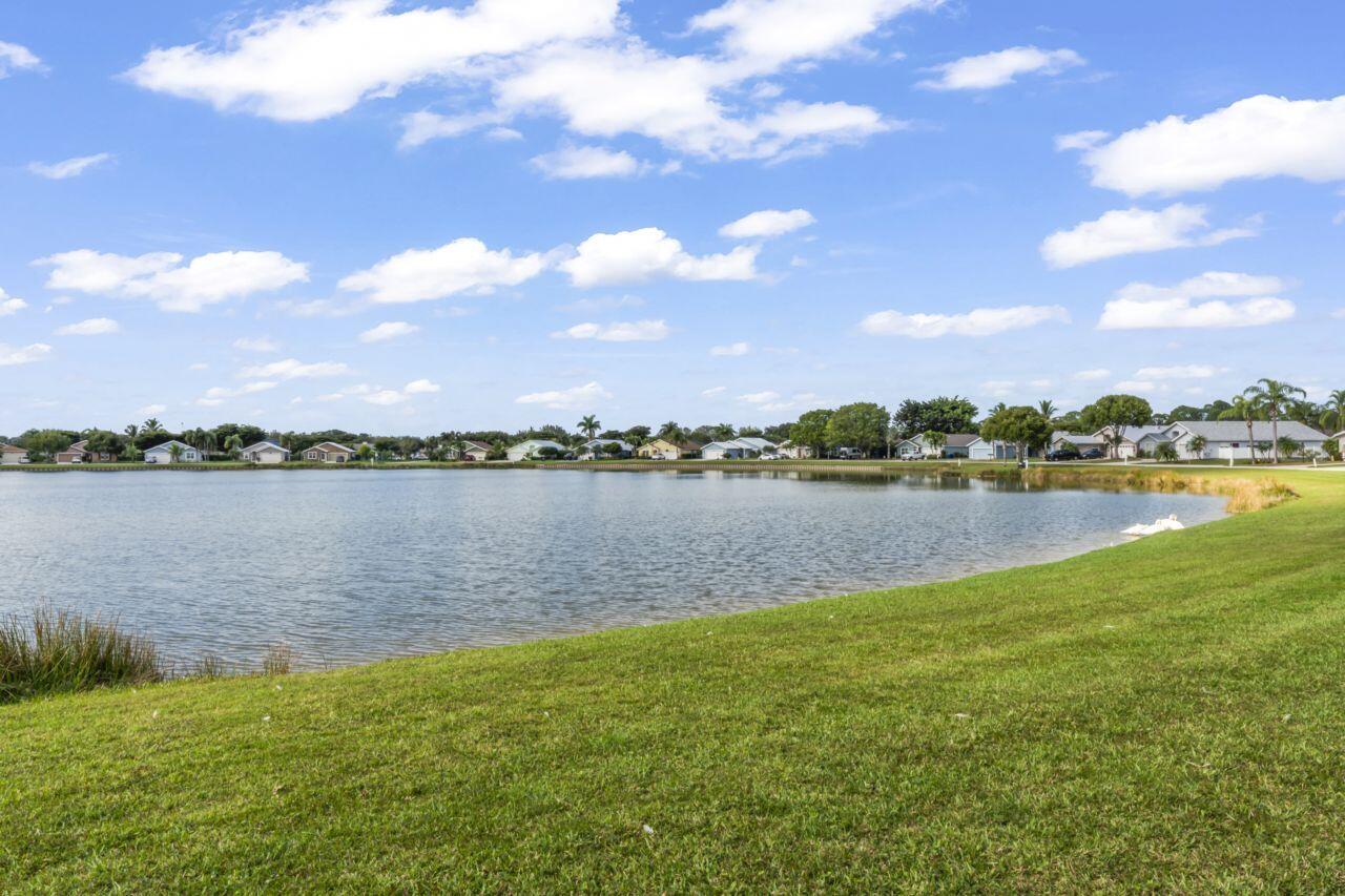 a view of a lake with houses in the back