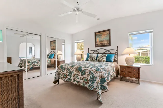 a spacious bedroom with a bed and dresser