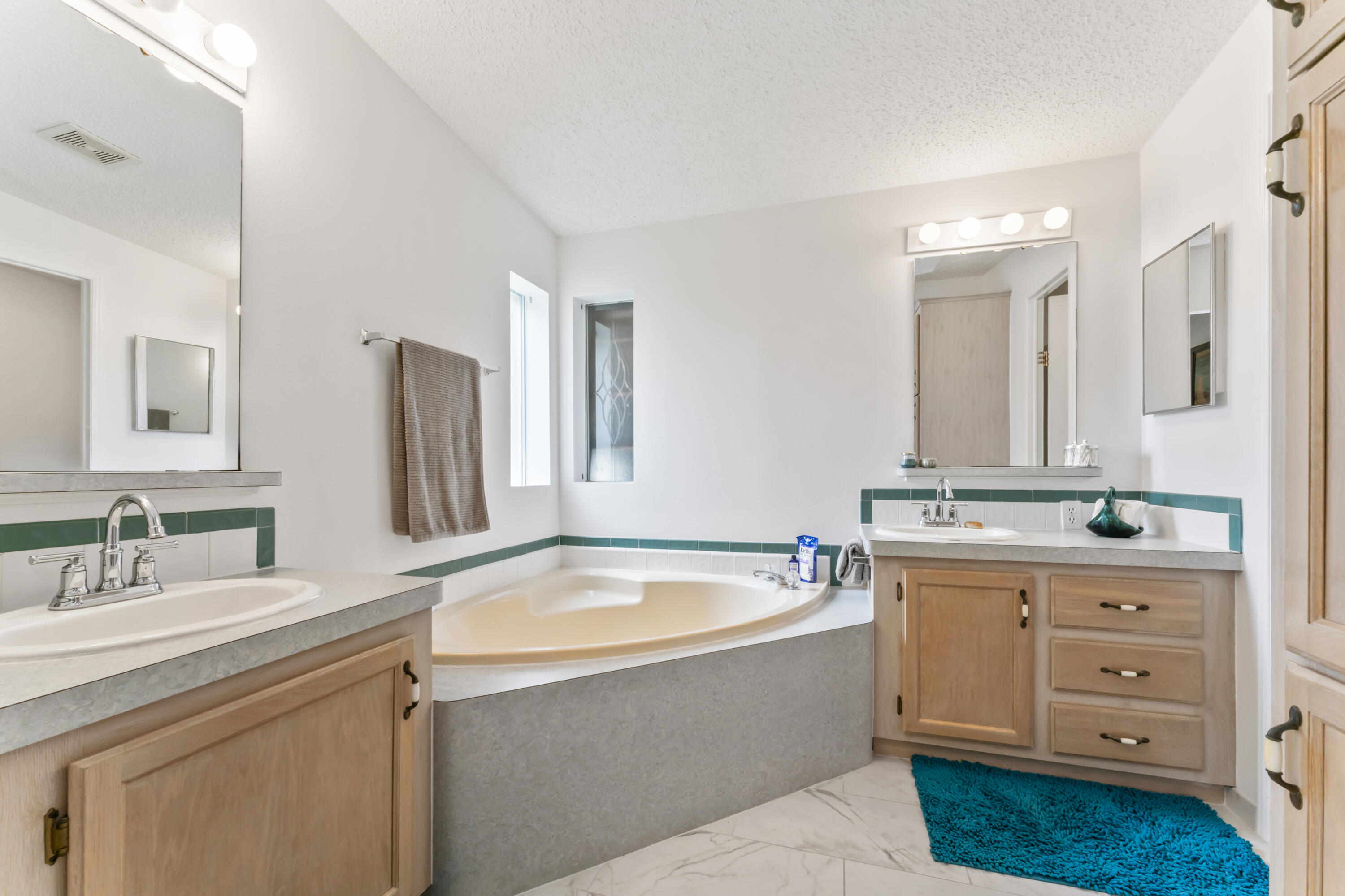 8913 Southwest Chevy Circle Stuart, FL 34997 - Photo 13 of 22 a bathroom with a tub sink and mirror