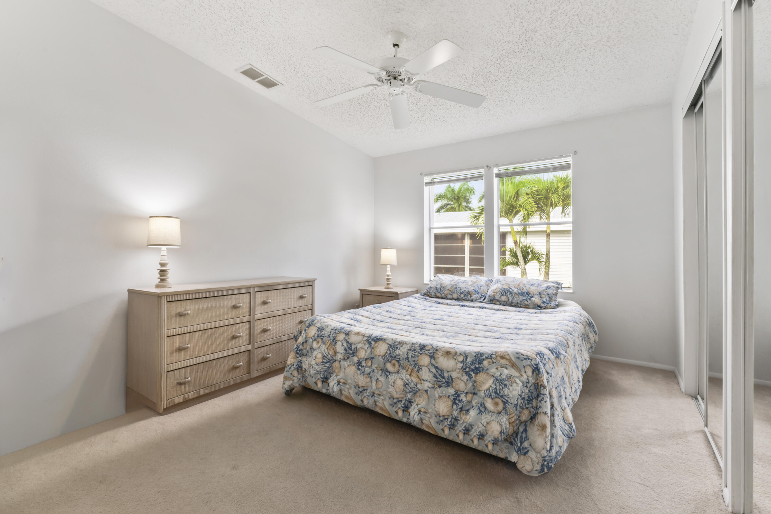 8913 Southwest Chevy Circle Stuart, FL 34997 - Photo 15 of 22 a bedroom with a bed and a dresser