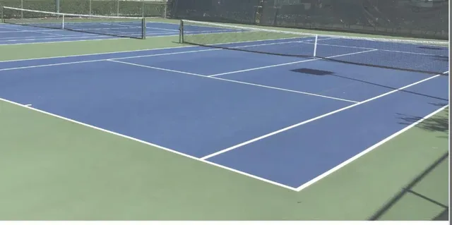 a view of an outdoor space and tennis court